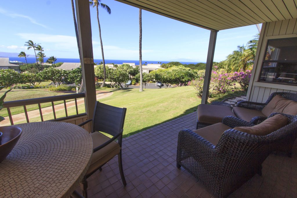Ocean view lanai has a dining table and large loungers